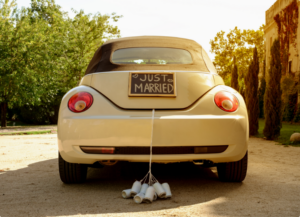 white vehicle with a "just married" sign