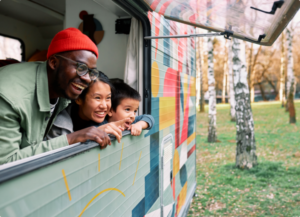 Dad looking out a window with two kids
