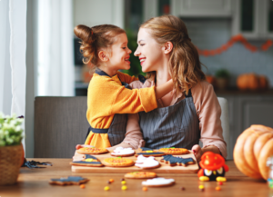 little girl baking with her mom