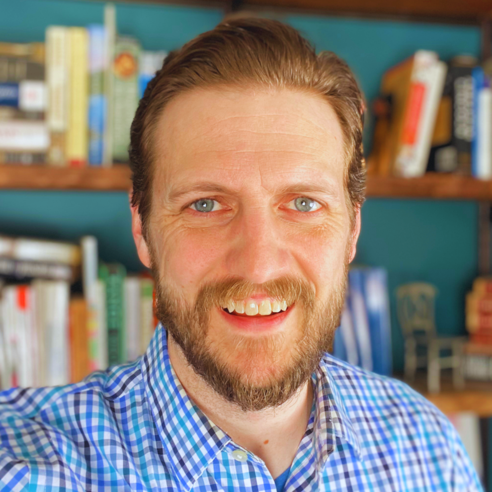 98450131_ans_headshot_bookshelf-filt_-_edited